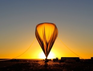 The high-altitude balloon that carried the HySICS instruments with WASP is inflated with helium at sunrise on the morning of Sept. 29, 2013. (HySICS Team/LASP)