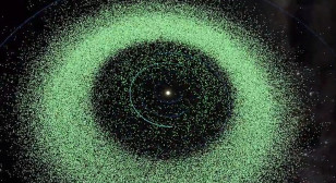 Each green dot represents an asteroid in our solar system which can vary in size from very small to large. The green circle indicates Earth's orbit.  Notice the number of asteroids within Earth's orbital path. ((c) B612 Foundation)