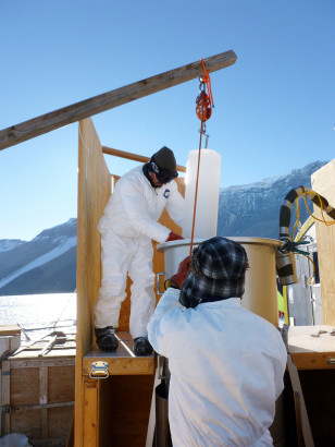 Scientists use a pulley system to load 25-kilogram ice cores into the melter setup. Scientists used the melter to extract air from bubbles formed in the ice.  The air samples were sent to a lab for analysis which indicated the samples to be 120,000 years old. (© Vasilii Petrenko/Oregon State University)