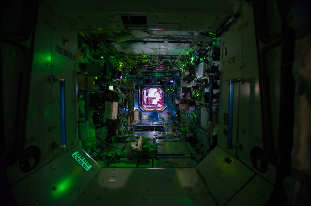 A look at the inside of the International Space Station while most of it's crew is asleep. This view looks  into the ISS' Destiny Laboratory from the Unity Node.  You can also see the Harmony Node in the background.  June 11, 2014 (NASA) 