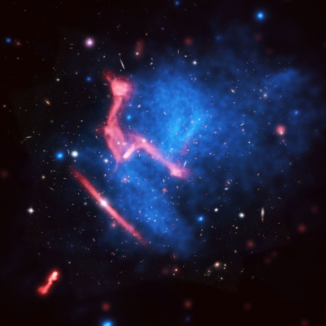This is another composite image that was taken with 3 different telescopes.  This composite is of the colliding galaxy clusters MACS J0717+3745 which are more than 5 billion light-years from Earth.  The background imaging is from the Hubble Space Telescope image, the blue colored imaging was taken with Chandra X-Ray Observatory and the red colored imaging was taken with the National Radio Astronomy Observatory’s Very Large Array (VLA). June 3, 21014 (NASA, NRAO/AUI/NSF)