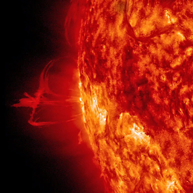 NASA released this photo on August 6, 2014, that shows a thin solar prominence above the Sun.  The prominence, which is controlled by the sun’s strong magnetic fields beneath it, then sprouted a number of plasma streams that disappeared back into the sun about a day later. NASA said that the photo was taken in extreme ultraviolet light. (NASA/SDO) 