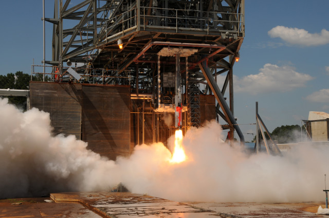 A 5-percent scale model of NASA’s Space Launch System (SLS) is ignited for a test at the space agency’s Marshal Space Flight Center in Alabama on August 28, 2014.  NASA engineers are using these tests to better understand just how loud the SLS vehicle will be during liftoff.  Data gathered from the tests will help the engineers design a water sound suppression system that reduces liftoff vibrations on the vehicle. (NASA)