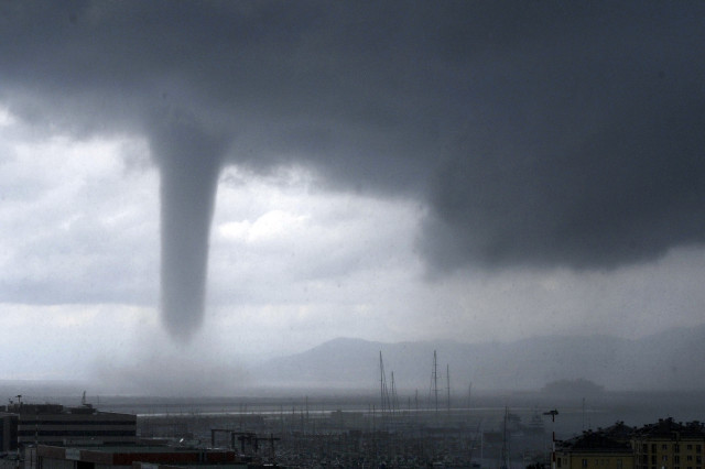 No, this is not a scene from the Wizard of Oz.  But, snapshot of a tornado as it nears the Italian city of Genoa, Aug 19, 2014. If you look carefully on the right and in background you should see the profile of the Costa Concordia cruise liner wreck which was towed to Genoa for scrapping. (AP)