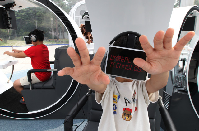 The Oculus Rift virtual reality headsets have become quite a popular feature at recent technology shows and conferences.  Here South Korean children enjoy a virtual reality experience at SK Telecom's "T.um mobile", a hands-on experience center that recently opened in Seoul South Korea. (AP)