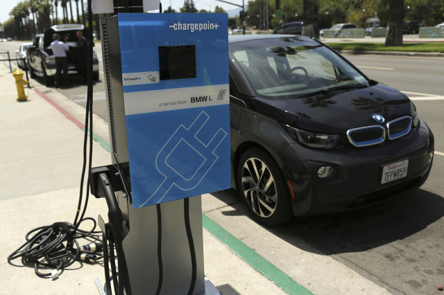 A BMW i3 electric car is parked next to its charger at the Electric Power Research Institute's ‘Plug-In 2014’ conference in San Jose, California on July 28, 2014.  Conference attendees were able to check out the latest electric car products and talked about improving both technological and marketing issues facing the rapidly growing plug-in vehicle industry. (Reuters) 