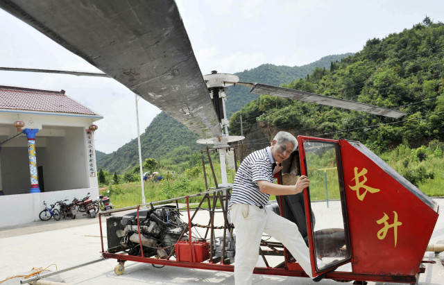 Jiang Changgen is shown here preparing to fly his home-built helicopter" in China’s Dexing, Jiangxi province.  Unfortunately, Jiang, who spent 100,000 yuan ($16,214 US) on his home-made chopper, was unsuccessful in his attempt to fly the craft, according to local media. (Reuters) 