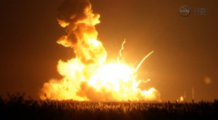 Orbital Sciences Corp.'s unmanned rocket blowing up over the launch complex at Wallops Island, Va., just six seconds after liftoff.  (NASA-TV)