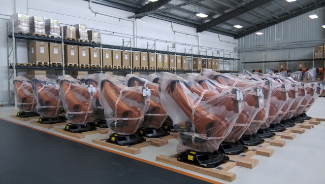 Rows of robots are covered in plastic sheets at a Kuka Robotics plant in Shanghai.  China said it wants domestic companies to buy more locally made robots to lift productivity, but industry insiders have warned these policies are over-stimulating the market. (Reuters) 