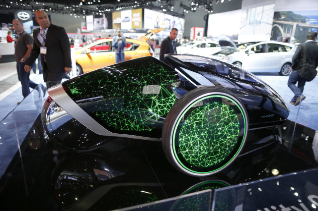 Visitors to the 2014 Los Angeles Auto Show are seen here, on November 20, 2014, examining the Toyota Future Mobility Concept car that was on display in Los Angeles, California. (Reuters) 