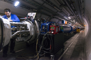 A technician works on CERN's Large Hadron Collider, which has been upgraded for its upcoming 2nd 3 year run. ((C) CERN)