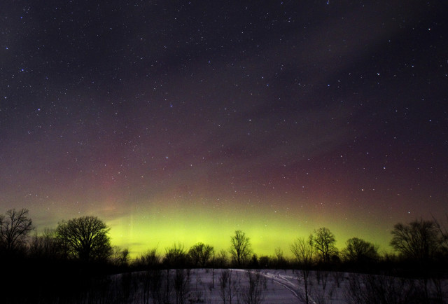 The glow of the Aurora Borealis, or Northern Lights, is seen in the horizon in the Kawartha Lakes region of southern Ontario 2/23/15.  The colorful Aurora Borealis, caused by charged particles from the sun, is rarely seen in Ontario.  (Reuters) 