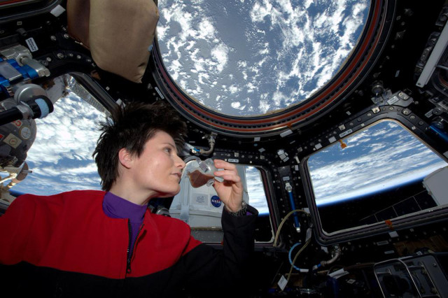 NASA posted this photo on 5/3/15, of Italian astronaut Samantha Cristoforetti sipping a cup of espresso aboard the International Space Station.  Her cup of the robust coffee was brewed with the first ever espresso machine in space. (NASA)