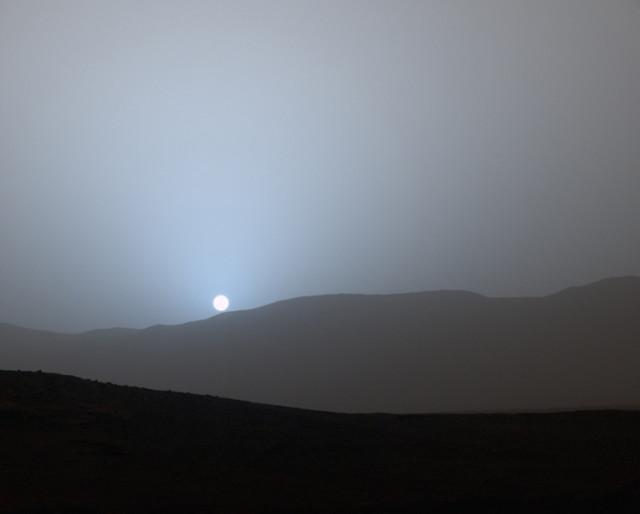 Sunset on Mars – On 5/8/15, NASA’s Jet Propulsion Laboratory released this color image captured a few weeks earlier by the Curiosity rover from its location in Gale Crater. (NASA/JPL-Caltech/MSSS/Texas A&M Univ.)