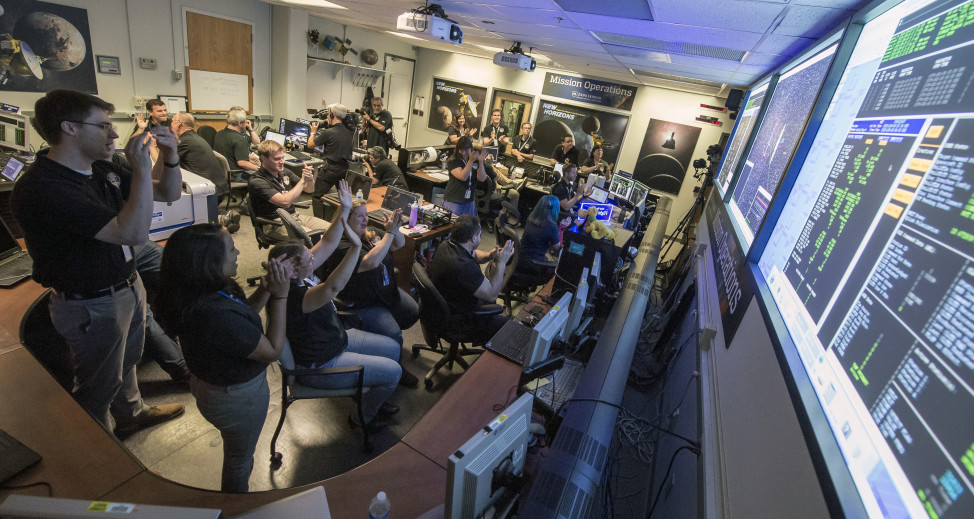 New Horizons Flight Controllers, at the Johns Hopkins University Applied Physics Laboratory in Laurel, Maryland, celebrate after they received confirmation that the NASA spacecraft had successfully completed its close flyby of Pluto on 7/14/15. (NASA)
