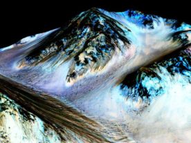 These dark, narrow, 100 meter-long streaks called recurring slope lineae flowing downhill on Mars are inferred to have been formed by contemporary flowing water. Recently, planetary scientists detected hydrated salts on these slopes at Hale crater, corroborating their original hypothesis that the streaks are indeed formed by liquid water. (NASA/JPL/University of Arizona)