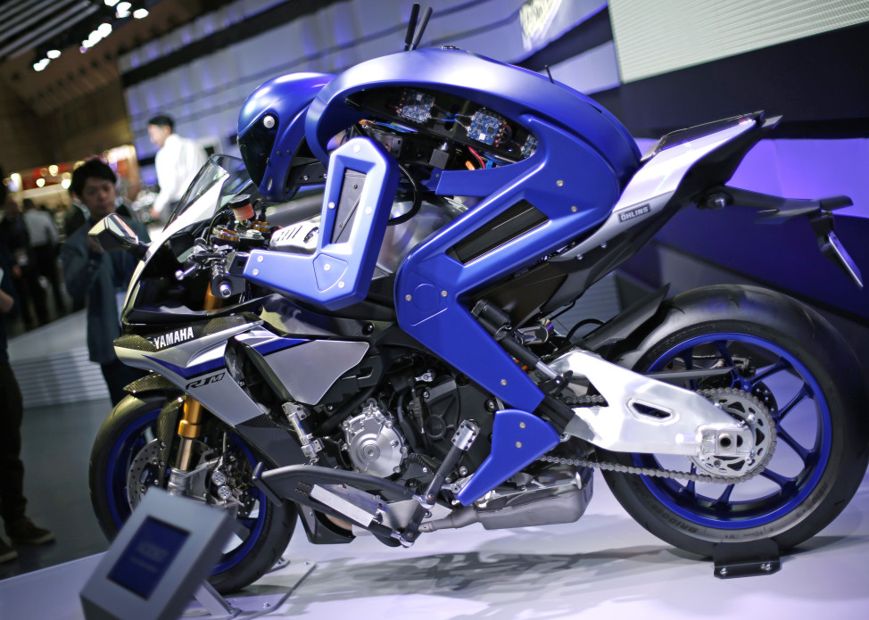 Yamaha's autonomous motorcycle-riding humanoid concept model is displayed during the 10/29/15 media preview of the Tokyo Motor Show in Tokyo. The Japanese vehicle exhibition opened to the public on 10/30/15 (AP)