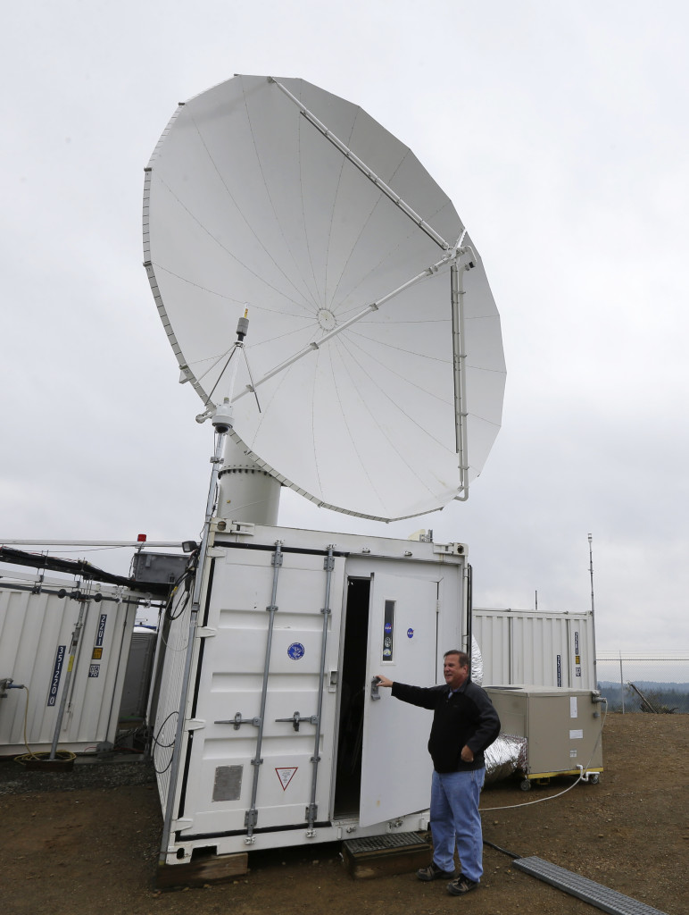 David Wolff, a research scientist with NASA, opens the door to a mobile workspace on a hilltop near Moclips, Washington on 11/6/15. Wolff and other scientists measured raindrops and snowdrops in one of the wettest spots in the US.  Scientists are attempting to validate, on the ground, how well global satellites measure precipitation from space. (AP)