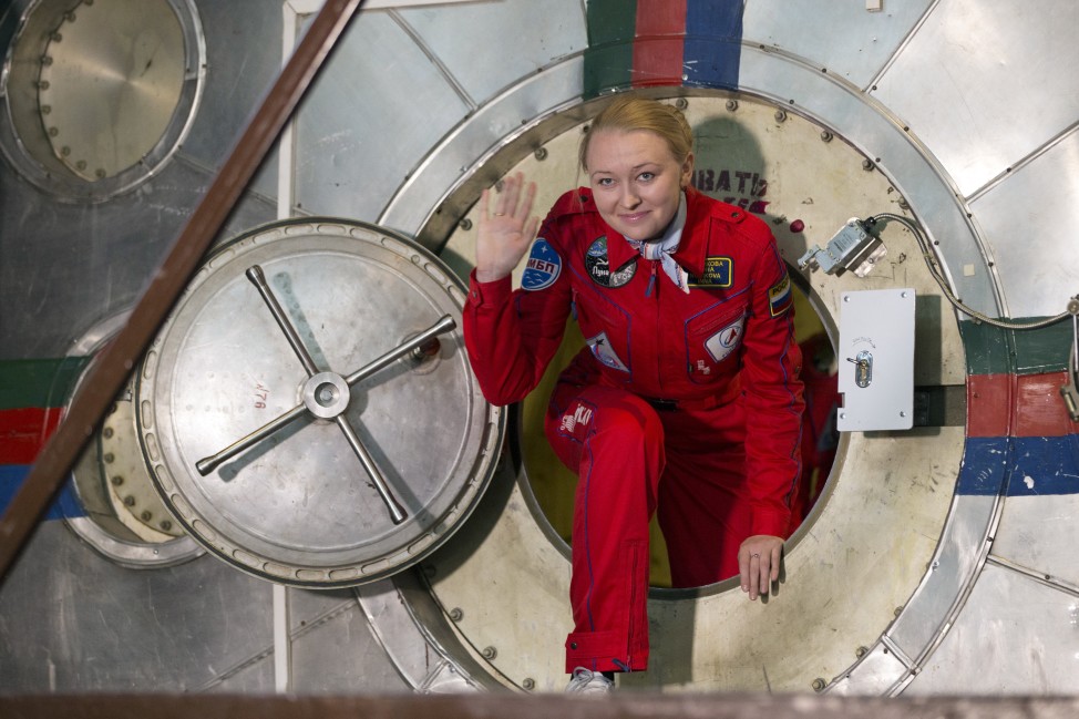 Inna Nosikova exits a mock-up spaceship after an eight-day simulated flight to the moon, in Moscow, Russia, on 11/6/15. Nosikova and her five female colleagues climbed into a grounded space capsule to imitate a lunar flight and test the effects of confinement and stress that come with space travel. (AP)
