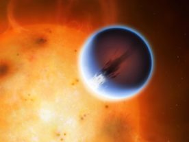 The planet HD 189733b is shown here in front of its parent star. A belt of wind around the equator of the planet travels at At nearly 8,700 kilometers per hour from its day side to the night side. The day side of the planet appears blue due to scattering of light from silicate haze in the atmosphere. The night side of the planet glows a deep red due to its high temperature. (Mark A. Garlick/University of Warwick)