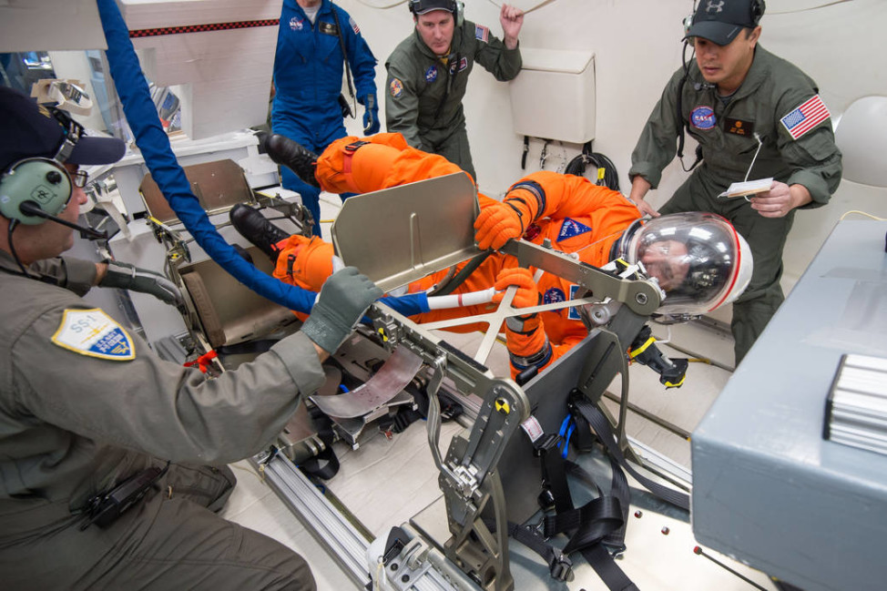 In a photo released 11/24/15, NASA tests a new spacesuit developed for the Orion spacecraft. The space agency’s engineers used a mockup of Orion’s cabin in the aircraft to evaluate how astronauts can get into their seats during various operational scenarios, perform tasks at different suit pressures, and to test seat hardware. (NASA)