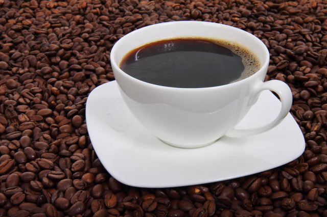 A cup of coffee on a bean background (Public Domain)