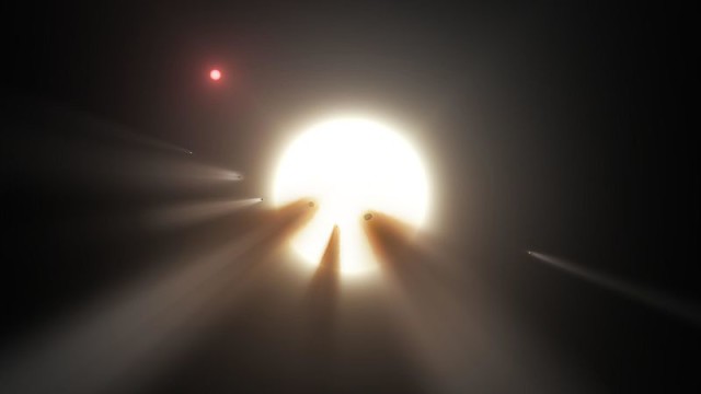 An orbiting swarm of dusty comet fragments are a possible explanation for the unusual light signal of KIC 8462852. (NASA/JPL-Caltech)