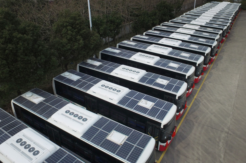 Buses with solar panels installed on their roofs to save electricity are seen in a parking lot in Hangzhou, Jiangsu Province, China, March 17, 2016. (Reuters) 