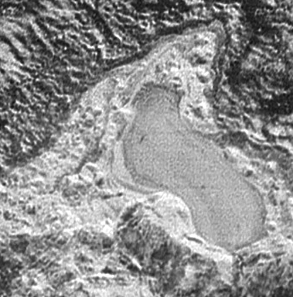 On March 24, 2016, NASA released an image captured by its New Horizons spacecraft of what it says appears to be a frozen, former lake of liquid nitrogen.  The feature is located in a mountain range just north of Pluto’s informally named Sputnik Planum. (NASA/JHUAPL/SwRI)