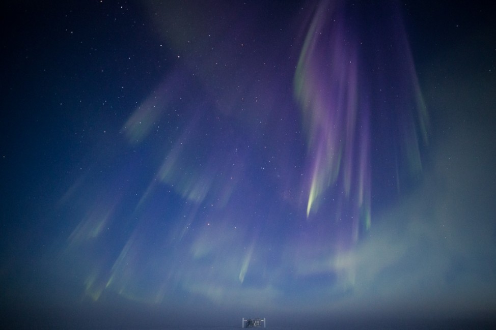 The first auroras of the season dance over the IceCube Neutrino Observatory a the South Pole. Long exposure and a steady hand are needed to capture them on film. (Photo by Hans Boenish)   