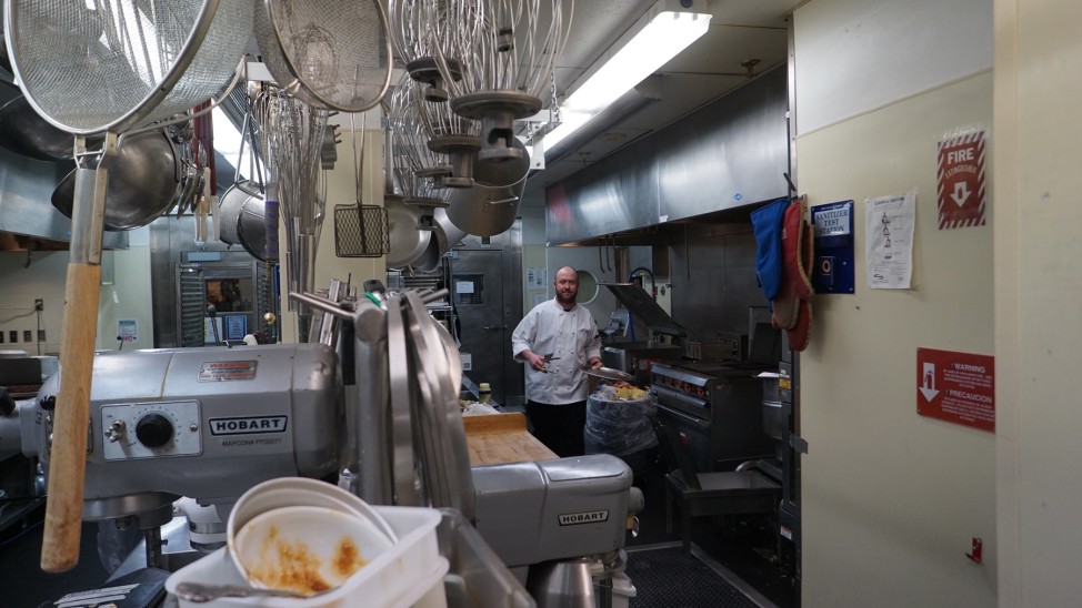 Head chef Darby Butts fries crab cakes for the pre-dinner cocktail hour. Along with a team of three, Butts put together the evening's menu.