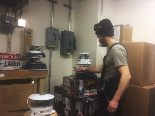 After sunset, the solar radiation equipment on top of ARO is removed.  Refael Klein takes time to inspect and re-organize the instruments.