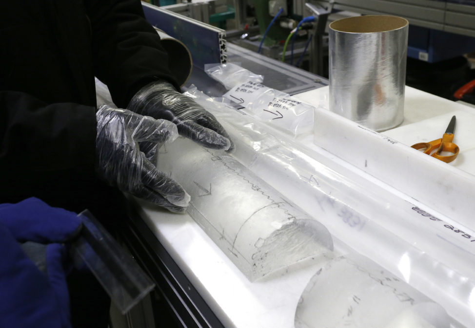 Geoffrey Hargreaves, curator of the National Ice Core Laboratory, is shown in this 8/8/16 photo, gently placing an arctic ice core on a table inside the deep freeze work area at the lab, in Lakewood, Colo. Scientists are able to look back at past cosmic event such as solar flares or other cosmic by the distinctive radioactive atoms left in the snow. Also dust blown in from distant continents can offer clues about atmospheric circulation. (AP)