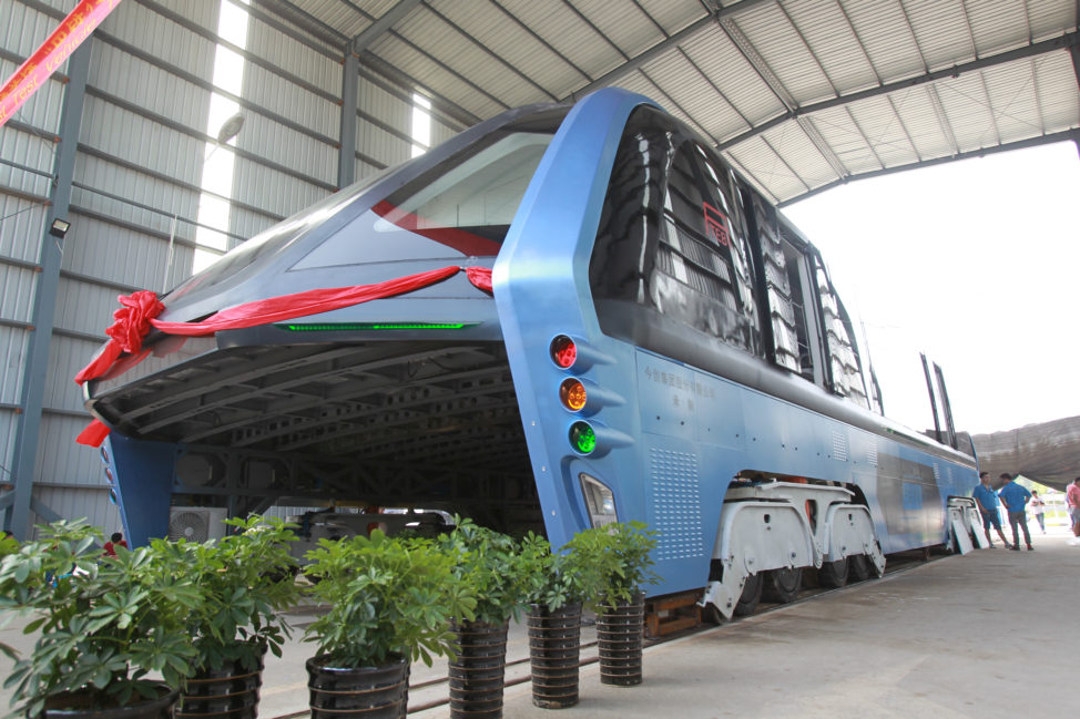 A model of an innovative street-straddling bus called Transit Elevated Bus is seen after a test run in Hebei Province, China, 8/3/16. According to local media this test is capable of carrying 300 people (Reuters)