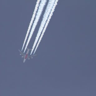 A commercial airliner produces a condensation trail in the skies over California. (Mick West)