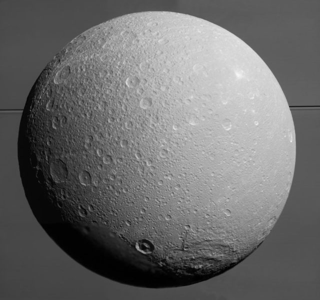 Dione with Saturn and its rings in the background. This image was taken by the Cassini spacecraft on 08/17/15 (NASA/JPL-Caltech/Space Science Institute)