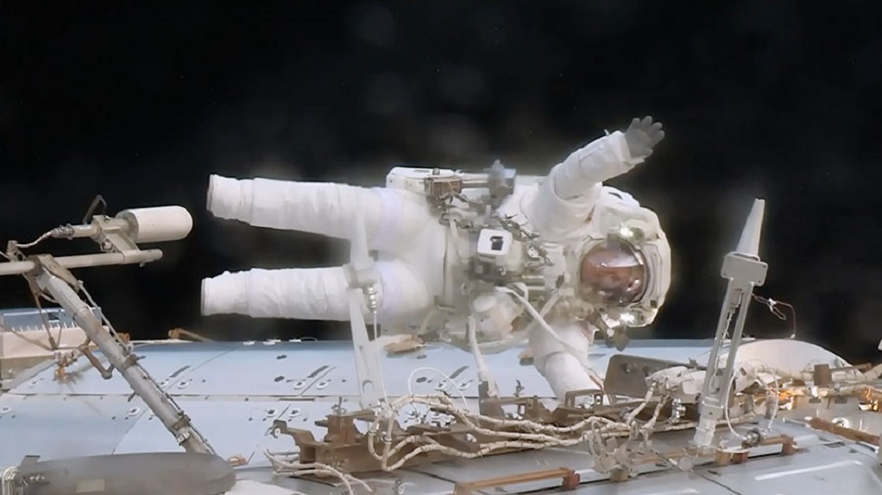 Astronaut Jack Fischer waves while attached to the International Space Station’s Destiny laboratory during a spacewalk with fellow Astronaut and ISS Expedition 51 Commander, Peggy Whitson on May 23. The two conducted the EVA to replace a failed data relay box and install a pair wireless antennas. (NASA)