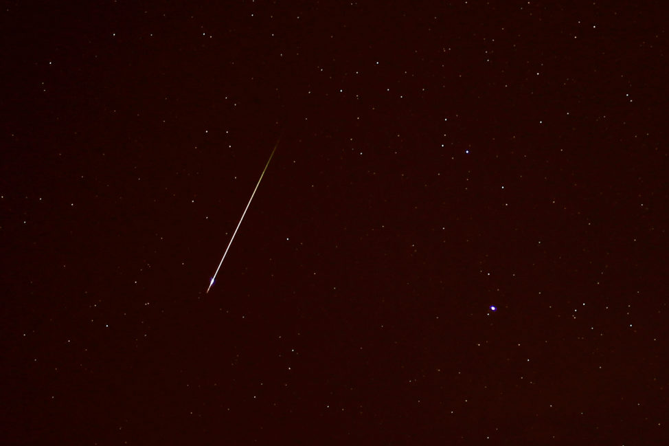 In a photo taken 10/22/17, near Malaga, Spain, a meteor is seen streaking past the constellation Canis Minor during the annual Orionid meteor showers. (Reuters)