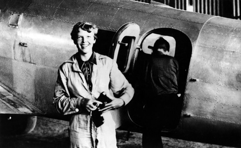 In a photo that is thought to have been taken on June 6, 1937 at Parnamerim airfield, Natal, Brazil, is American aviator Amelia Earhart standing by her Lockheed Electra. Her flight navigator, Fred Noonan, can be seen getting into the plane in the background. (Flickr's the Commons)