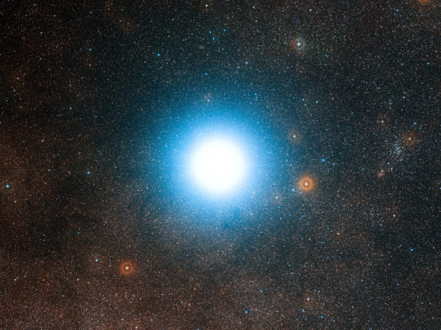 The Breakthrough Starshot initiative hopes to send a fleet of tiny spacecraft on a flyby of our neighboring galaxy Alpha Centauri. This wide-field view of the sky around the bright star Alpha Centauri was created from photographic images forming part of the Digitized Sky Survey 2. (ESO/Digitized Sky Survey 2/Davide De Martin)