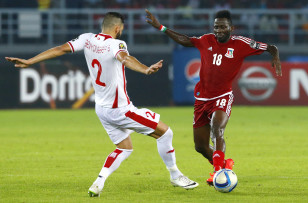 Tunisia's Syam Ben Youssef challenges Equatorial Guinea's Wahbi Khazri iduring their quarter-final soccer match of the 2015 African Cup of Nations in Bata