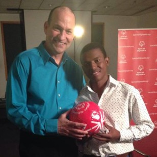 Sonny and Bright hold a Special Olympics soccer ball.