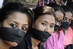 Members of the All Assam Photojournalist Association wear black sashes around their mouths to protest against the rape of a photo journalist by five men inside an abandoned textile mill in Mumbai, in the northeastern Indian city of Guwahati, Aug. 24, 2013. (Reuters)