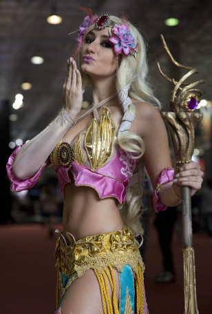 A woman dressed as "Smite" video game character poses for portraits as she cosplays at the Comic Con Experience fair in Sao Paulo, Brazil, Dec. 4, 2014. (AP)