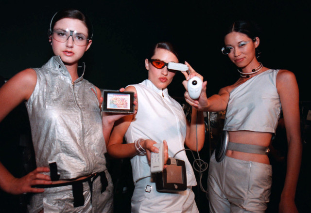 Models display a wireless mini-computers and other high tech gadgets, June 14, 2000, during the "Brave New Unwired World" fashion show at Bravo! located in downtown Minneapolis. (AP)