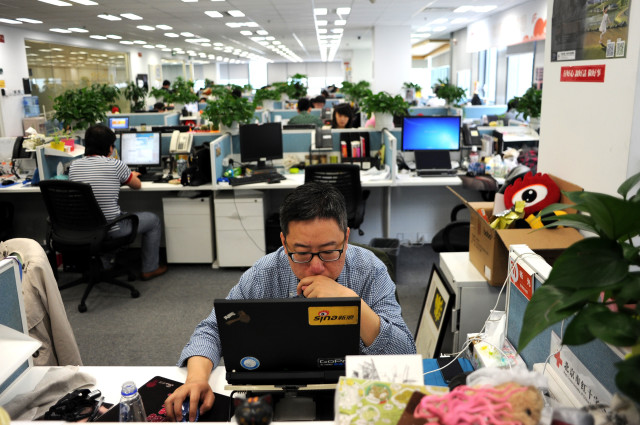 A picture taken April 16, 2014 shows a man using a laptop at an office of Sina Weibo, widely known as China's version of Twitter, in Beijing. (AFP)