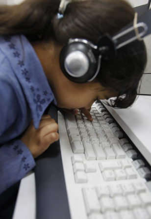 A visually impaired girl uses the computer at the Royal Academy for the Blind in Amman, Jordan, NOV. 22, 2011. (Reuters)