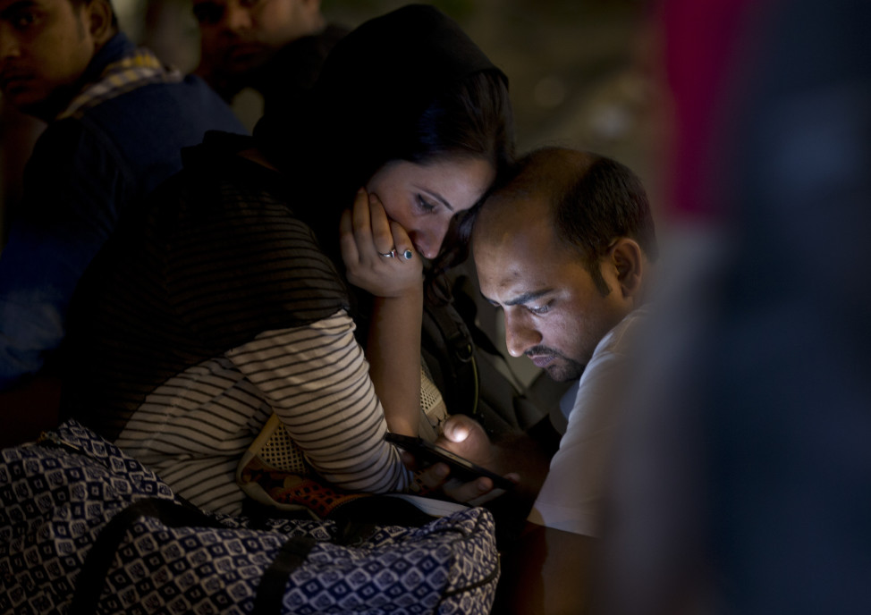 Indians use a mobile phone at a market area in New Delhi, Sept. 27, 2015, following a rare visit to Silicon Valley by Indian Prime Minister Narendra Modi. (AP)