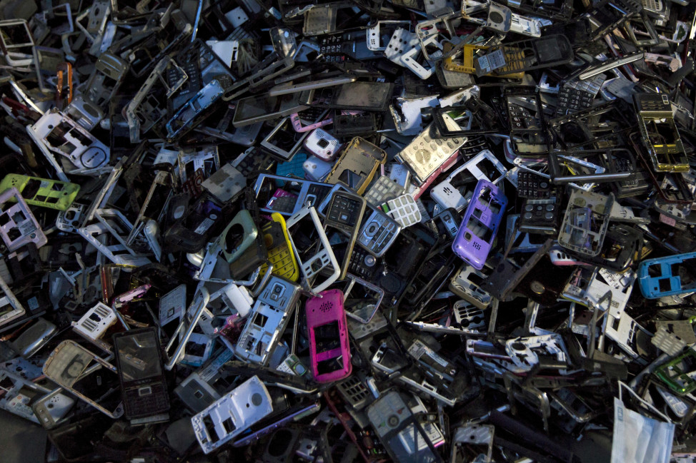 Old cellular phone components are discarded inside a workshop in the township of Guiyu in China's southern Guangdong province, June 10, 2015. (Reuters)