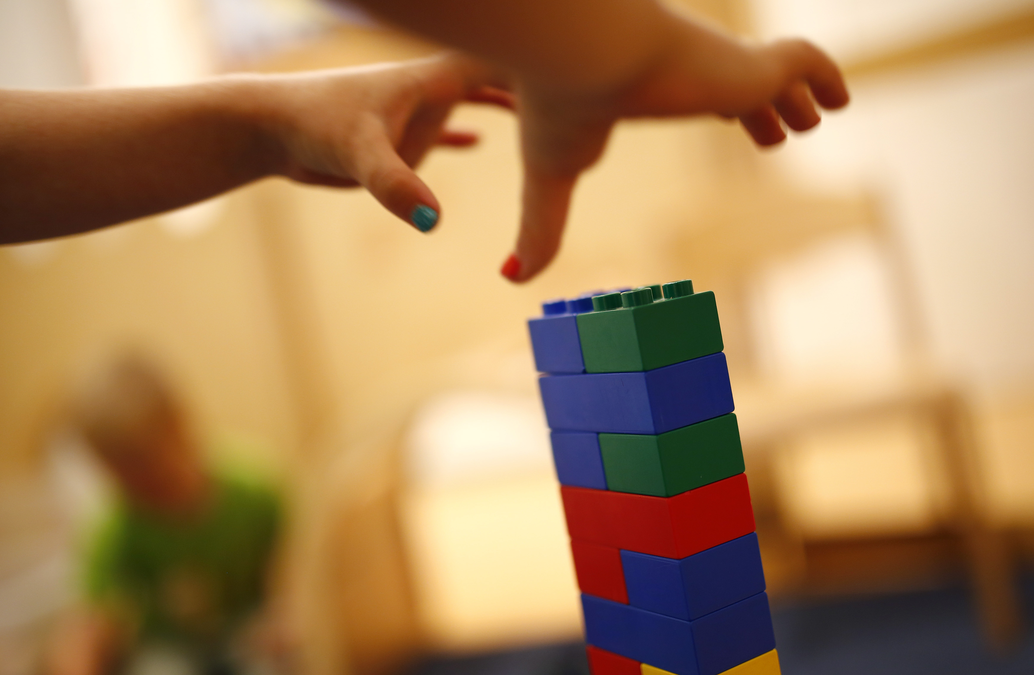 FILE - A child grabs LEGO bricks at a Kindergarten in Hanau, Germany, July 16, 2013. (Reuters)